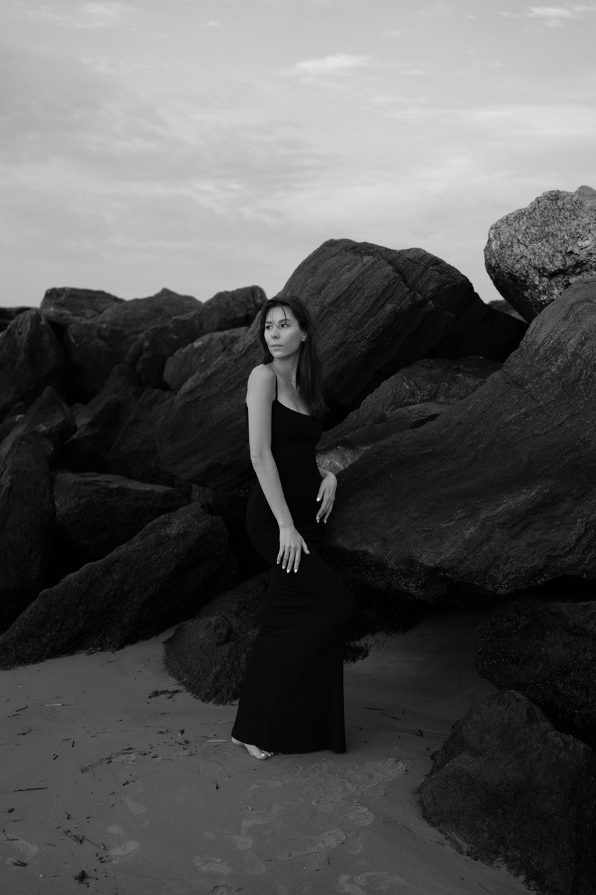 Portrait by rocks on the beach